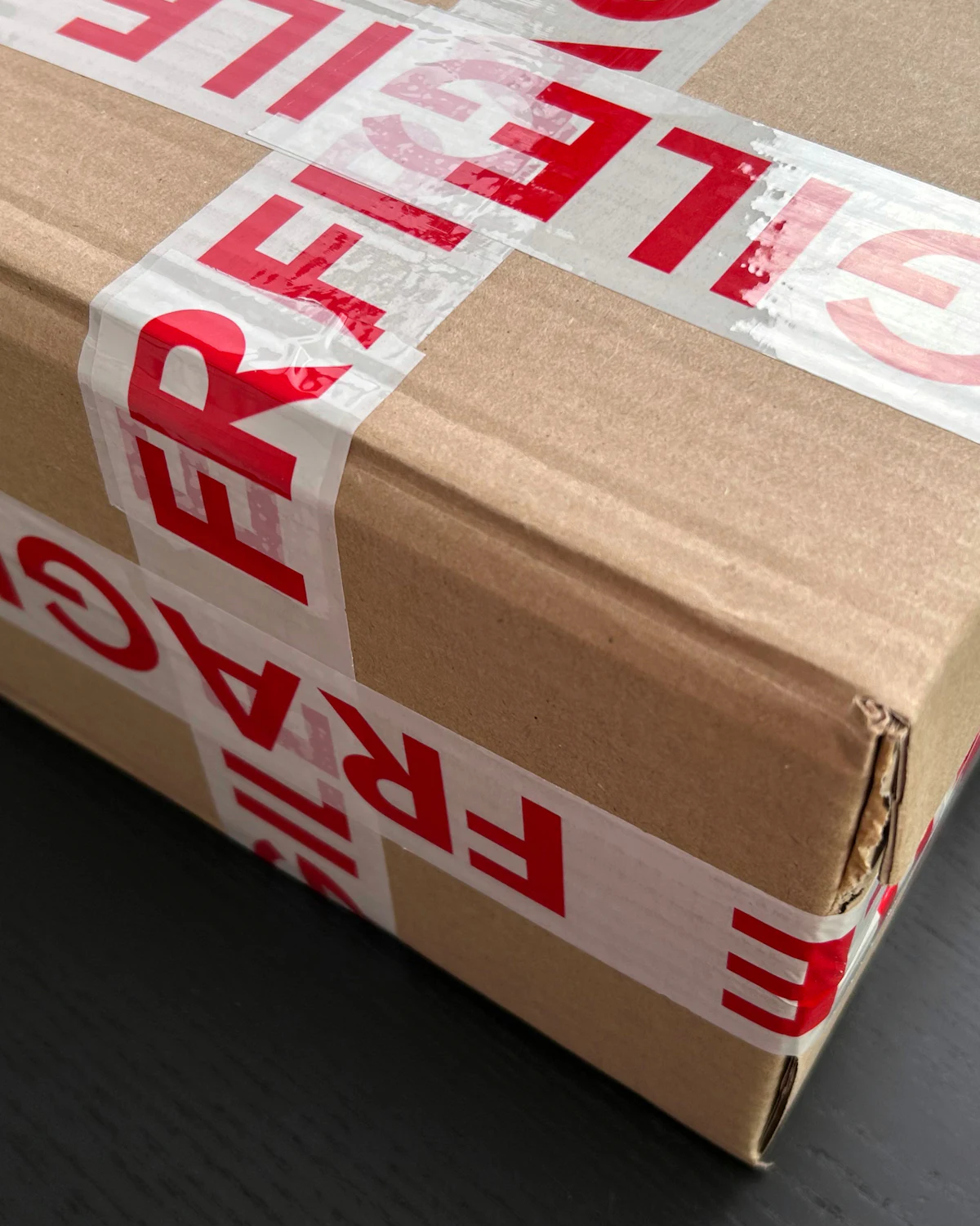 Cardboard box sealed with fragile tape