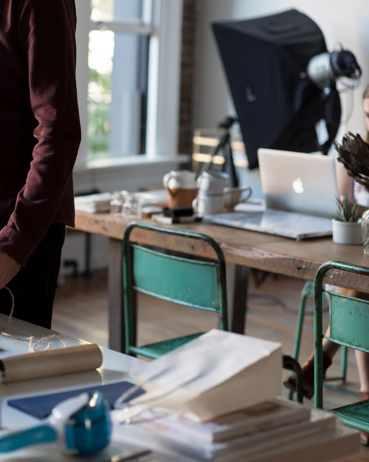 Seller holding a packed cardboard box at a desk